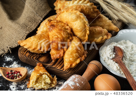 Homemade pies with cabbage on a wooden  table 48336520