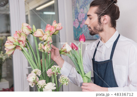 Small business. Male florist in flower shop. Floral design studio, making decorations and 48336712