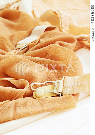 A pair of old stockings with garters A pair of old stockings with garters 48336989