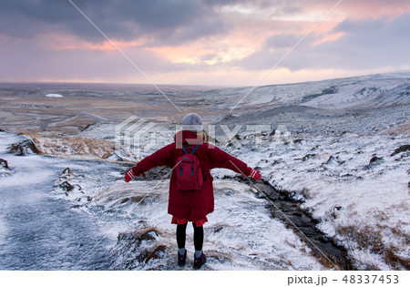 Female traveler on a sunrise hike in Iceland 48337453