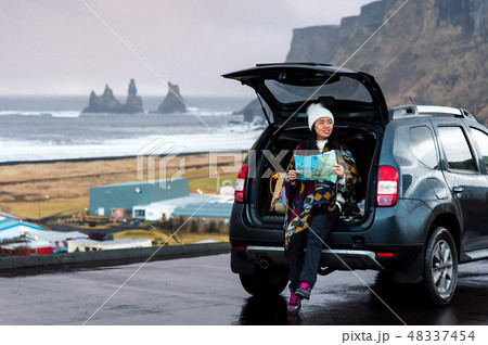 Traveler with map planning the trip from the car 48337454