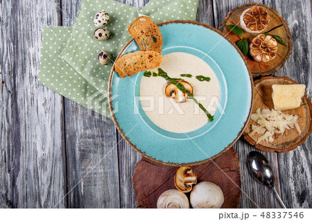 Bowl with delicious mushroom soup on wooden table 48337546