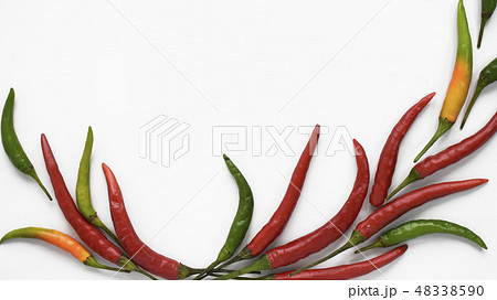 Fresh chili peppers vegetables flat lay isolated on white. Red, green, orange colorful Capsicum Fresh chili peppers vegetables flat lay isolated on white. Red, green, orange colorful Capsicum 48338590