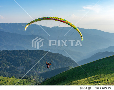 Yellow paraglider in blue clear sky 48338949