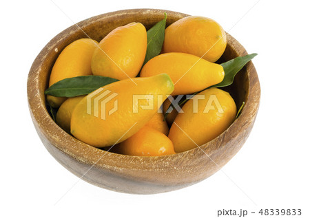 Ripe sweet orange kumquats in wooden bowl Ripe sweet orange kumquats in wooden bowl 48339833