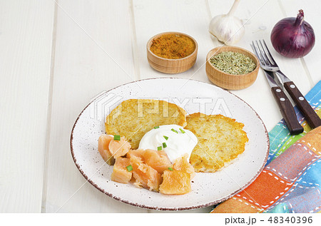Potato pancakes with white sauce and smoked salmon 48340396