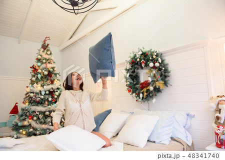 Holidays, celebration and people concept - young woman over christmas interior background. 48341740