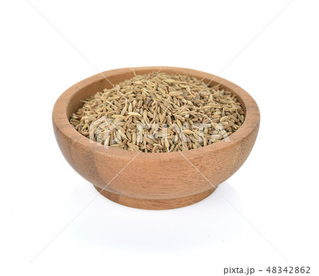 Caraway seeds in wooden bowl on white background Caraway seeds in wooden bowl on white background 48342862