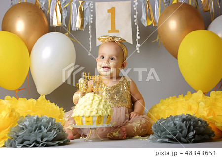 Little baby girl eating birthday cake during cake smash party Little baby girl eating birthday cake during cake smash party 48343651