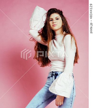 young cute girl on pink background smiling adorable emotional posing 48344129
