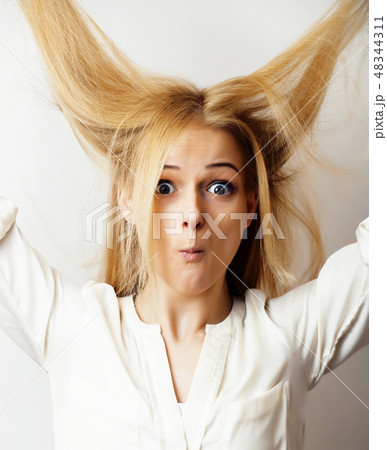 young blond woman on white backgroung gesture thumbs up, isolated emotional posing close up young blond woman on white backgroung gesture thumbs up, isolated emotional posing close up 48344311