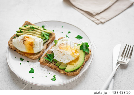 Poached Eggs and Avocado Sandwiches 48345310