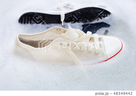 Soak shoes before washing. Dirty sneakers. Soak shoes before washing. Dirty sneakers. 48349442