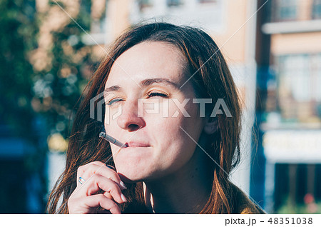 real cute woman smokes a cigarette real cute woman smokes a cigarette 48351038