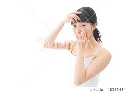 コンタクトレンズを装着する若い女性 48355484