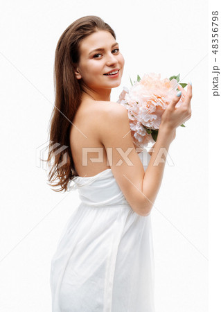 Portrait girl smiling and posing with artificial flowers on white background. Portrait girl smiling and posing with artificial flowers on white background. 48356798