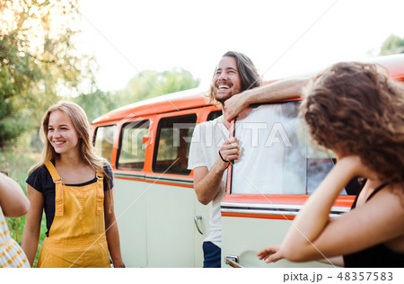 A group of young friends on a roadtrip through countryside. A group of young friends on a roadtrip through countryside. 48357583