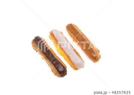 Delicious chocolate eclaire isolated over white background Delicious chocolate eclaire isolated over white background 48357635