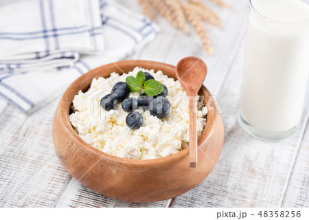 Tvorog or cottage cheese in wooden bowl Tvorog or cottage cheese in wooden bowl 48358256