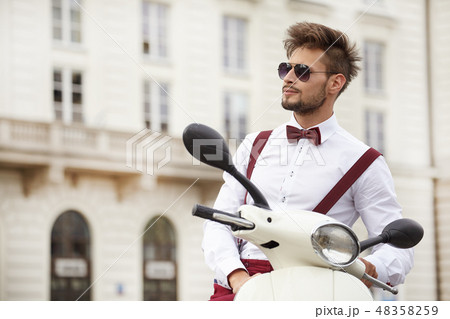 Hipster fashion men with scooter on a sunny day in the city 48358259