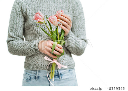 Young woman holding pink tulips on a white background. 48359546