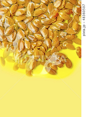 Linseeds olive oil on yellow. Omega 3-6-9 vitamin. 48360507