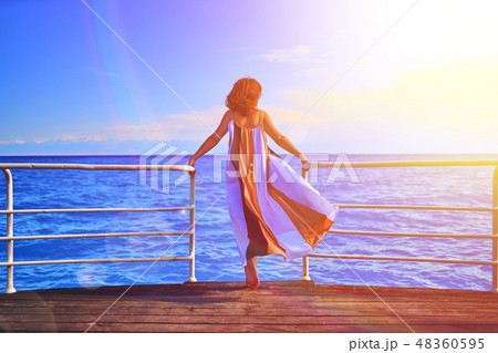 Behind girl on pier. 48360595