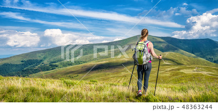 Young woman hiking in the mountains Young woman hiking in the mountains 48363244