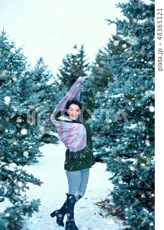beautiful woman in winter forest, green fir trees 48365121