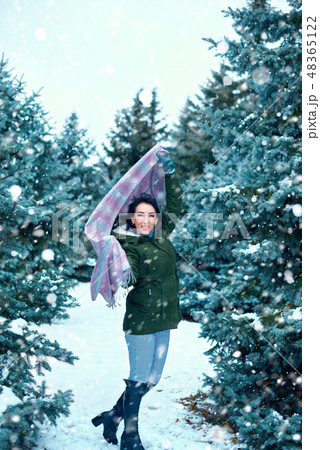 beautiful woman in winter forest, green fir trees 48365122