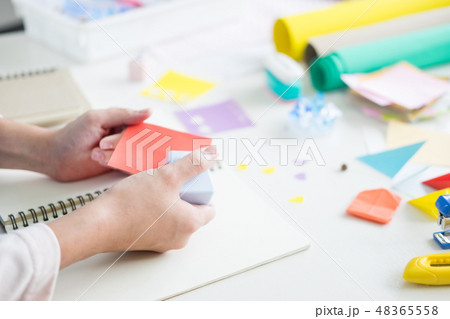 Woman's hand cut paper Making a scrap booking or other festive d Woman's hand cut paper Making a scrap booking or other festive d 48365558