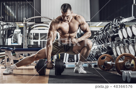 guy bodybuilder with dumbbell guy bodybuilder with dumbbell 48366576