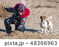 little girl in hat and jacket in the winter plays  48366963