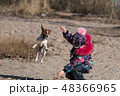 little girl in hat and jacket in the winter plays  48366965