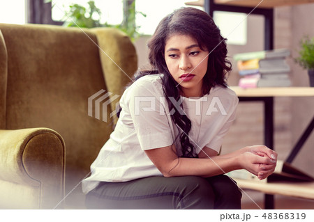 Depressed cheerless brunette woman feeling very lonely Depressed cheerless brunette woman feeling very lonely 48368319