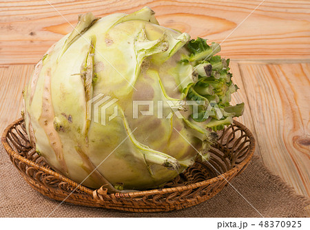 fresh cabbage kohlrabi on a light wooden background fresh cabbage kohlrabi on a light wooden background 48370925