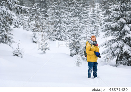 The photographer in winter forest in mountains 48371420