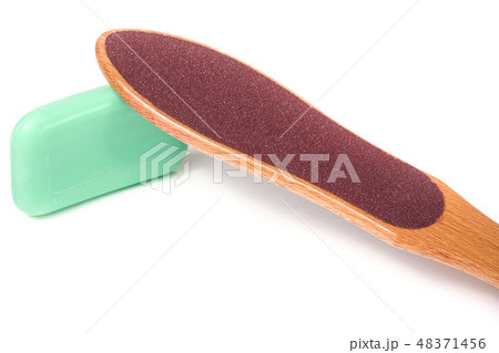 wooden double-sided grater for feet with soap isolated on white background 48371456