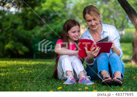 Happy mother and little kid daughter in park. Happy mother and little kid daughter in park. 48377695