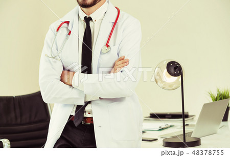 Male doctor crossed arms standing in the hospital. Male doctor crossed arms standing in the hospital. 48378755