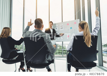 Businesswomen and businessmen in group meeting. Businesswomen and businessmen in group meeting. 48378870