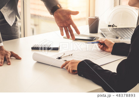 Architect and engineer working with drawing. Architect and engineer working with drawing. 48378893