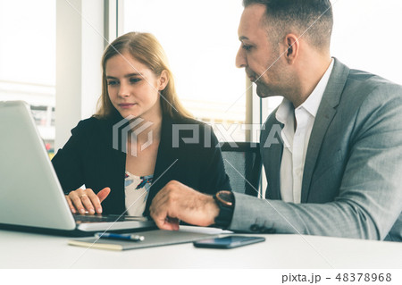 Businessman and businesswoman working in office. Businessman and businesswoman working in office. 48378968