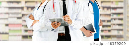 Doctor working in hospital with other doctors. 48379209