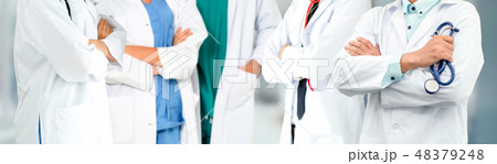 Doctor working in hospital with other doctors. 48379248