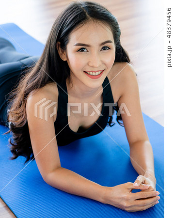 Young woman practice yoga in an gym studio. Young woman practice yoga in an gym studio. 48379456