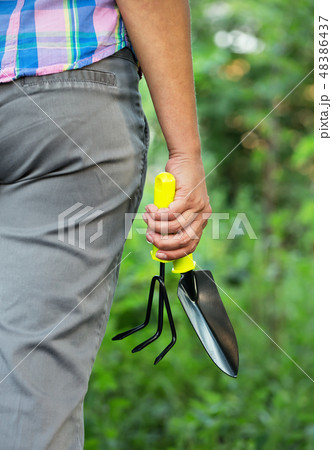 Woman's hand with garden tool 48386437
