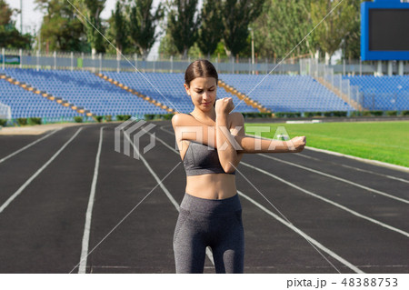 Sport girl doing stretching her arms. Sport girl doing stretching her arms. 48388753