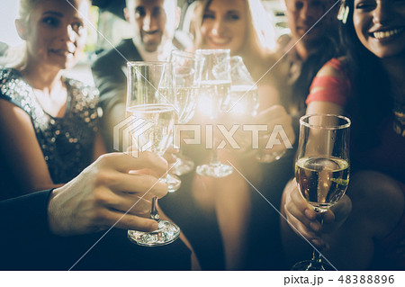 Party crowd clinking glasses with champagne Party crowd clinking glasses with champagne 48388896