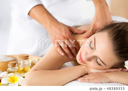 Beautiful young woman laying at spa salon 48389353